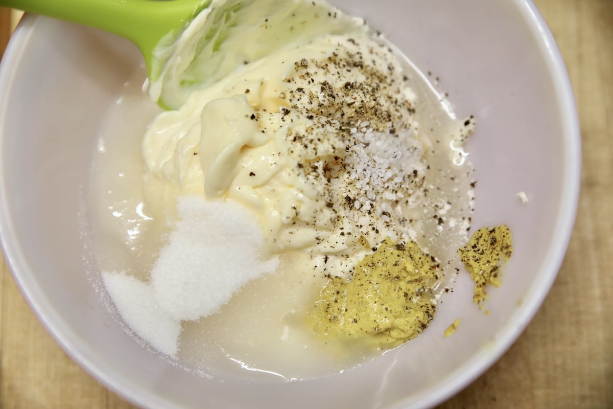 Bowl with creamy dressing ingredients.