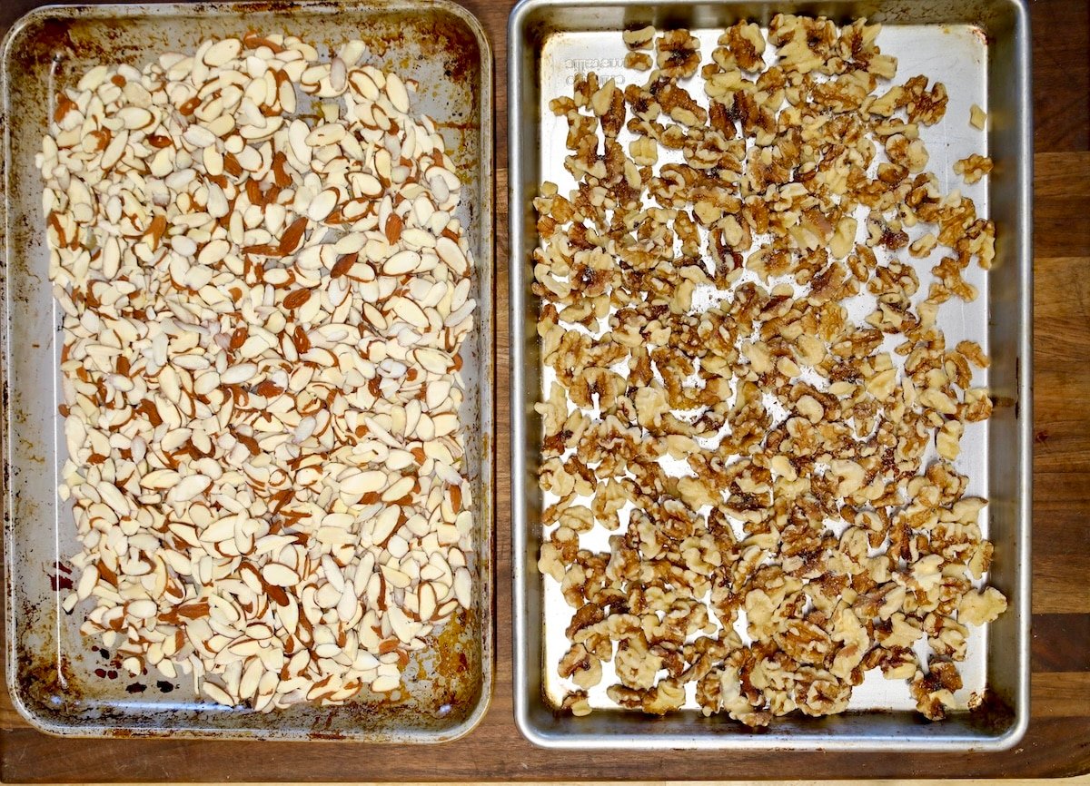 Pan of sliced almonds, pan of walnut halves.