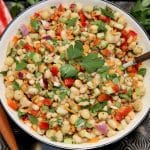 Bowl of white bean salad with s spoon.