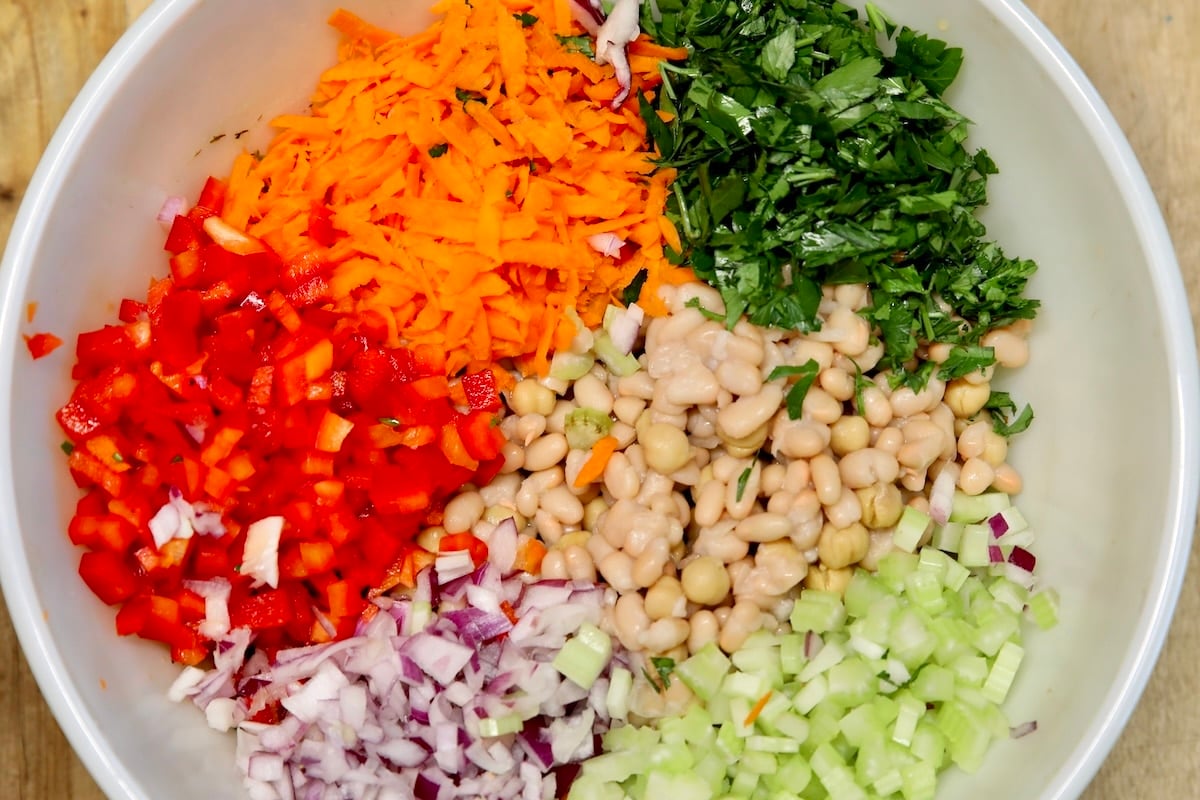 Salad ingredients in a bowl: beans, vegetables.