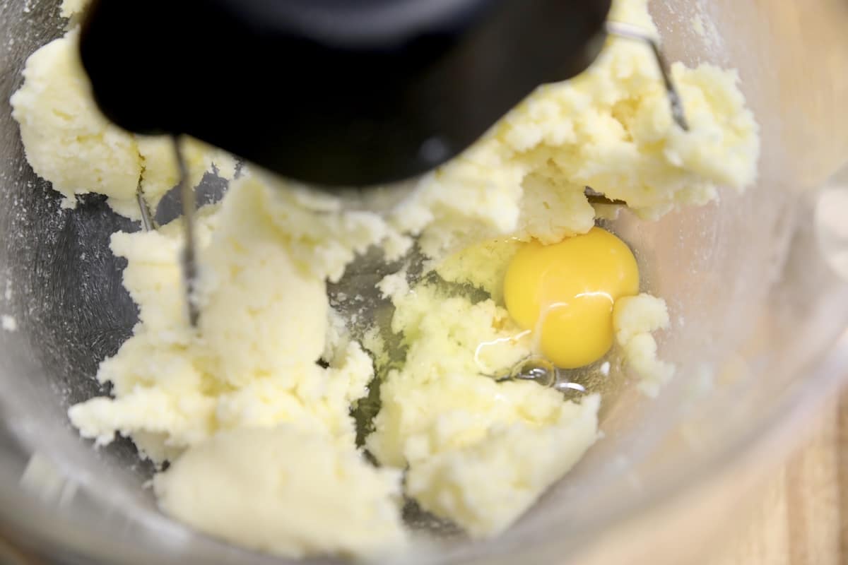 Creamed butter and sugar in a bowl with egg.