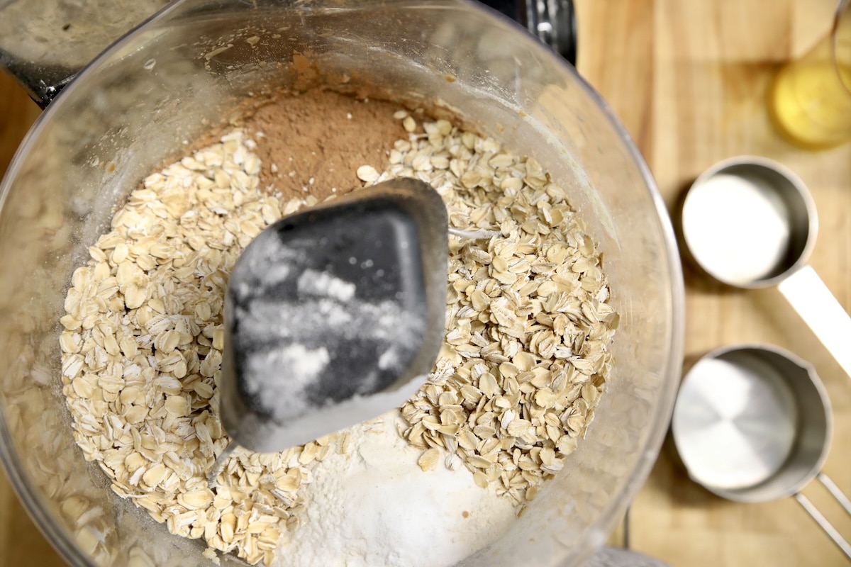 adding oats, flour, cocoa powder in a mixing bowl.