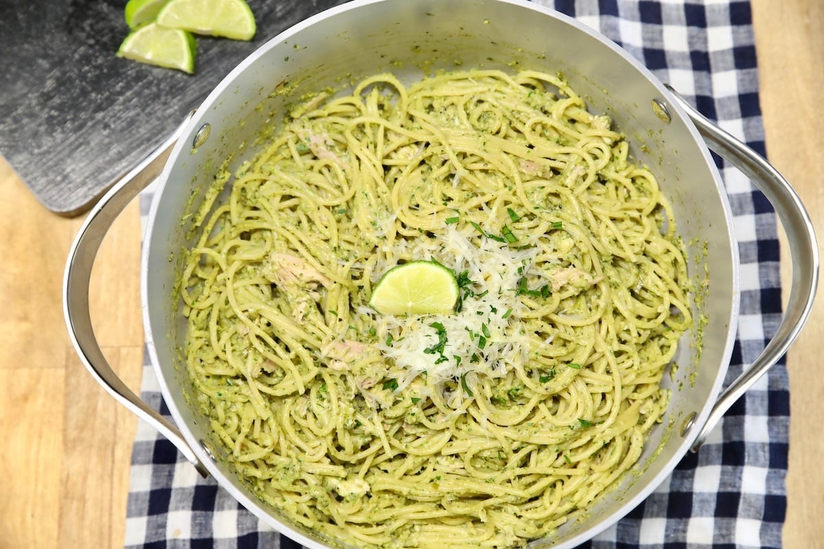 Pan of green spaghetti with parmesan.