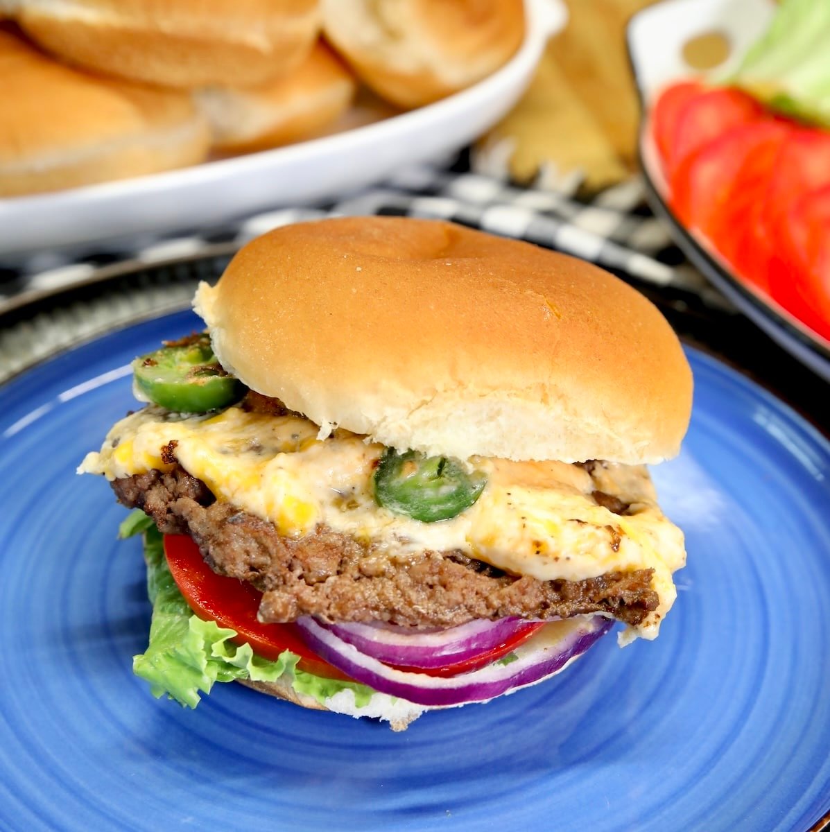 Jalapeno popper burger on a blue plate.