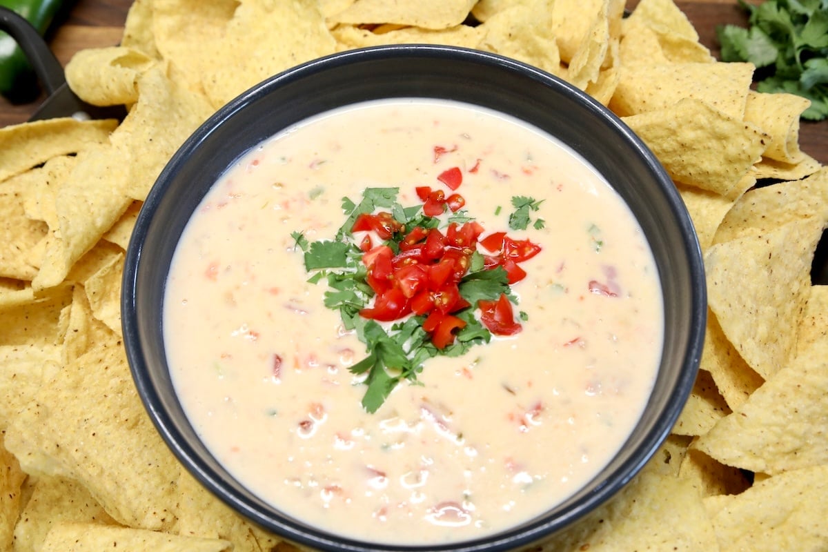 Bowl of white queso with chips.