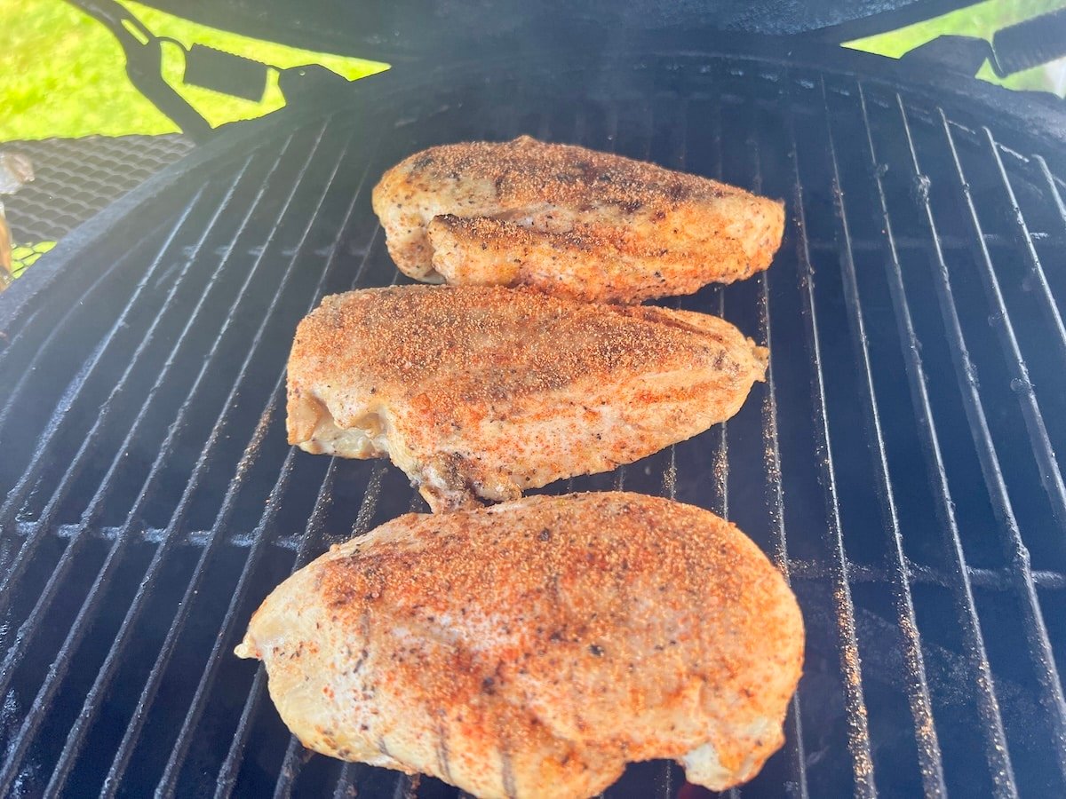 Chicken breasts on a grill.