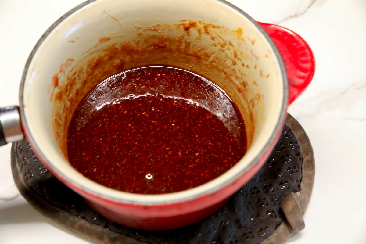 Raspberry chipotle sauce for dip in a pan.