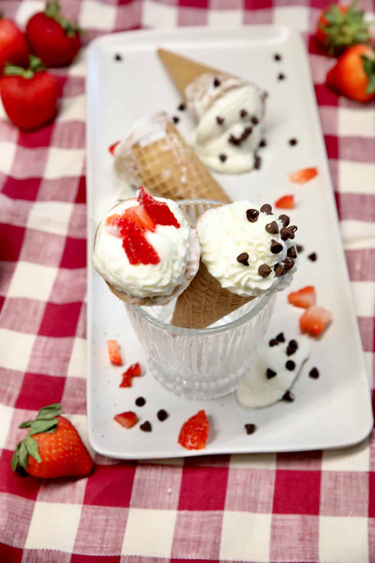 Frozen cheesecake cones with strawberries and chocolate chips.