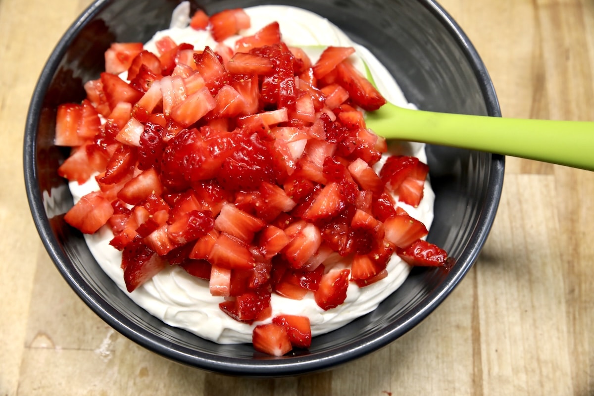 Cheesecake filling with diced strawberries on top.