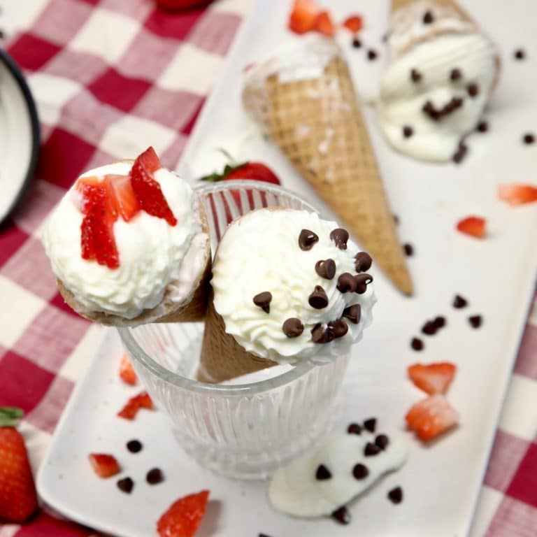 Frozen cheesecake cones with strawberries and mini chocolate chips.