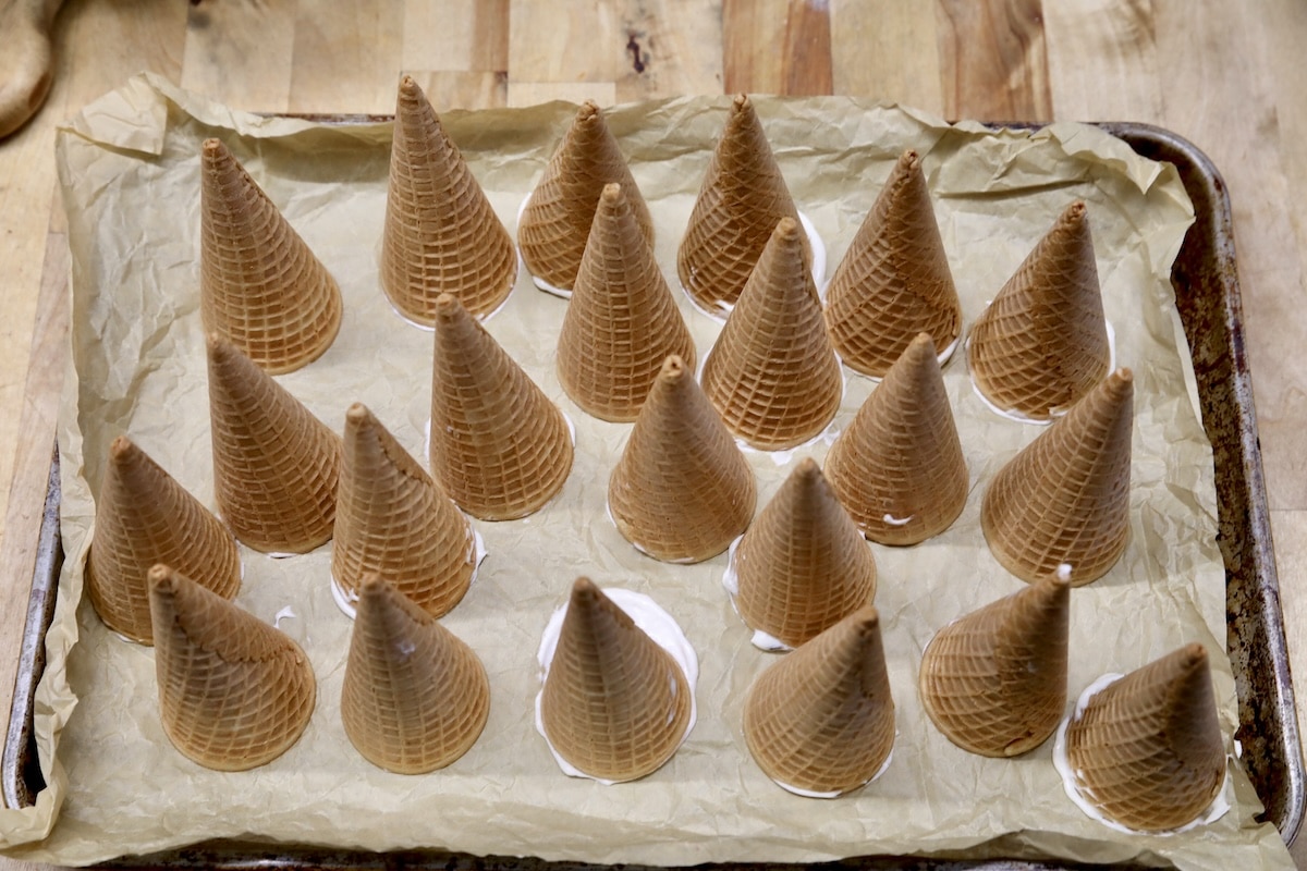 Sugar cones upside down on baking sheet.