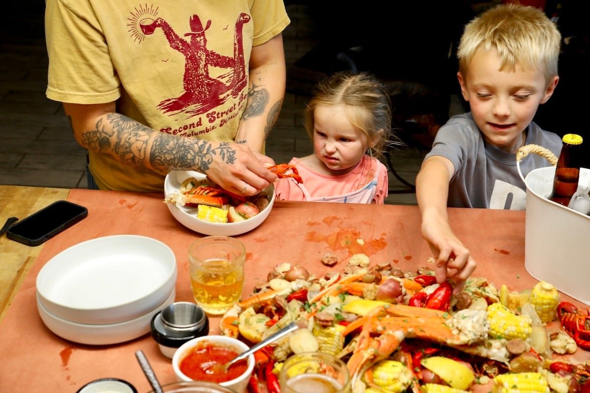 Kids and woman with seafood boil. 
