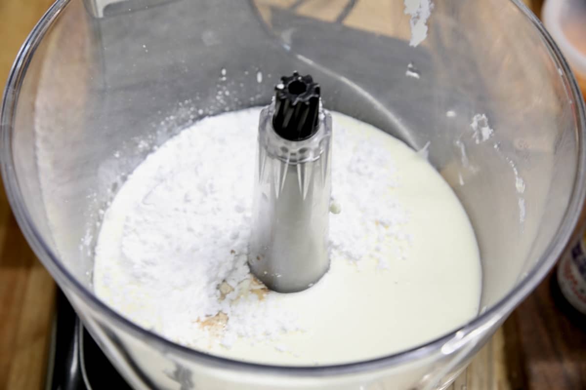 Bowl of heavy whipping cream with powdered sugar.