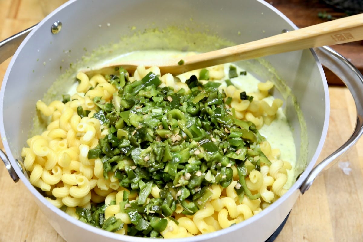 Pan of pasta with chopped poblanos and cheese sauce.