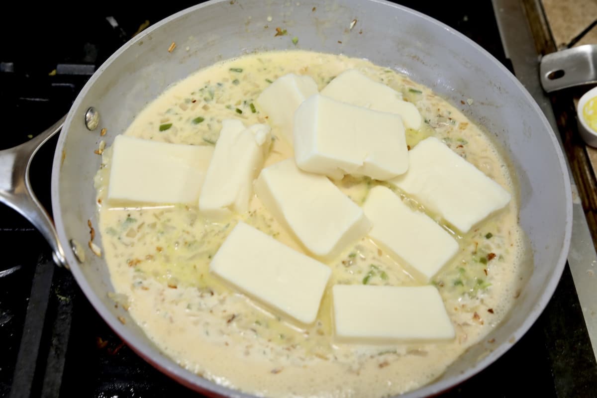 Adding white cheese to pan for dip.