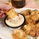 Chicken dipping in bbq ranch sauce.