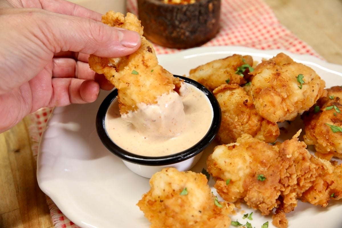 BBQ Ranch dipping sauce and salad dressing. Chicken dipping into bowl of sauce.