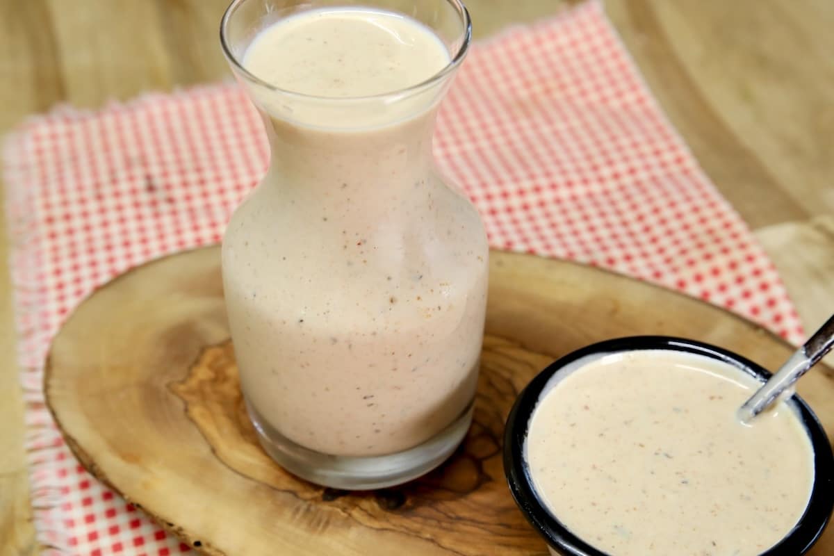 Small bottle  and sauce cup with bbq ranch dressing.