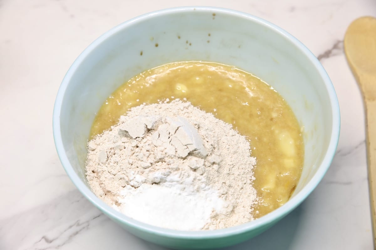 Bowl with mashed banana mixture, flour.