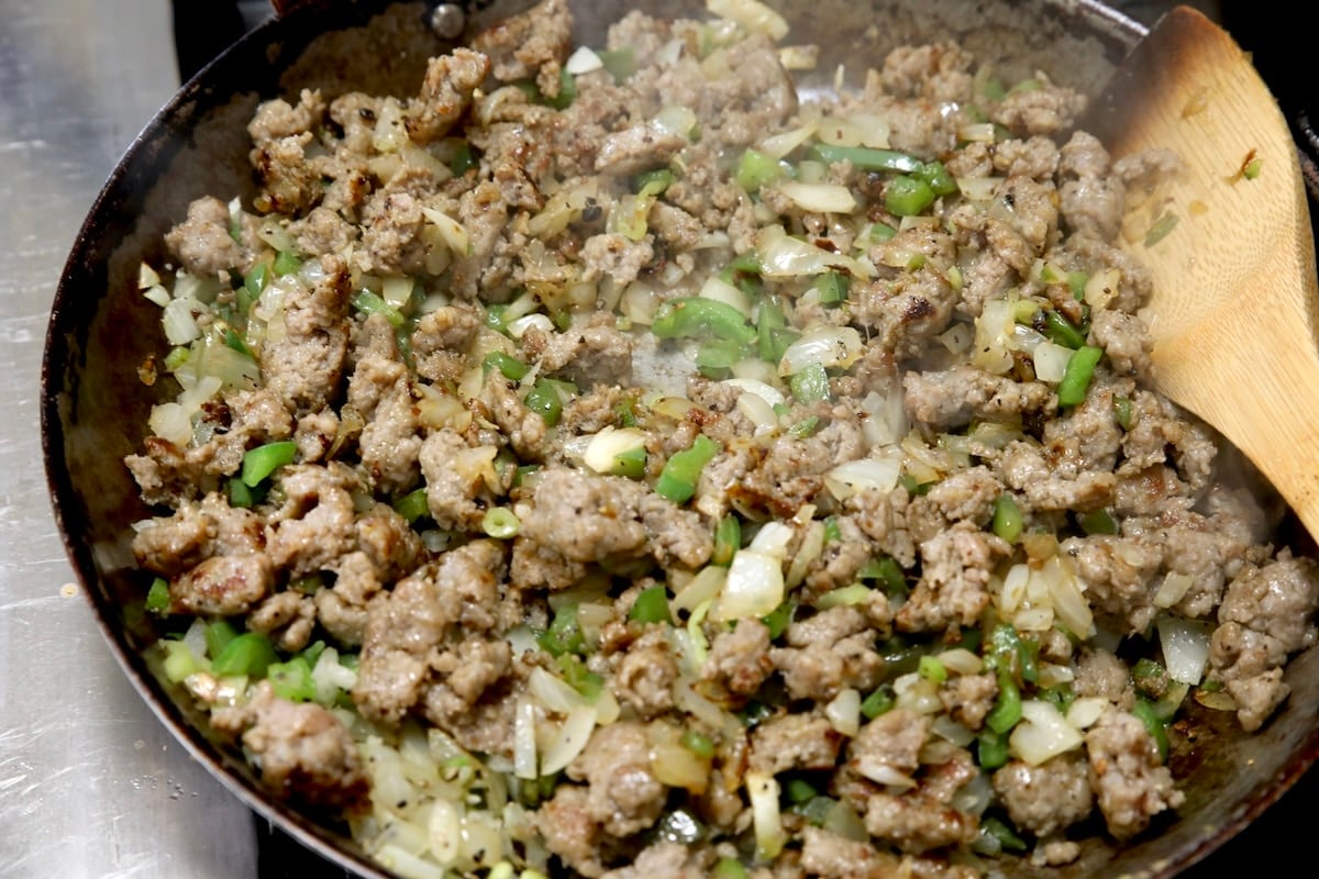 Cooking sausage in a skillet.