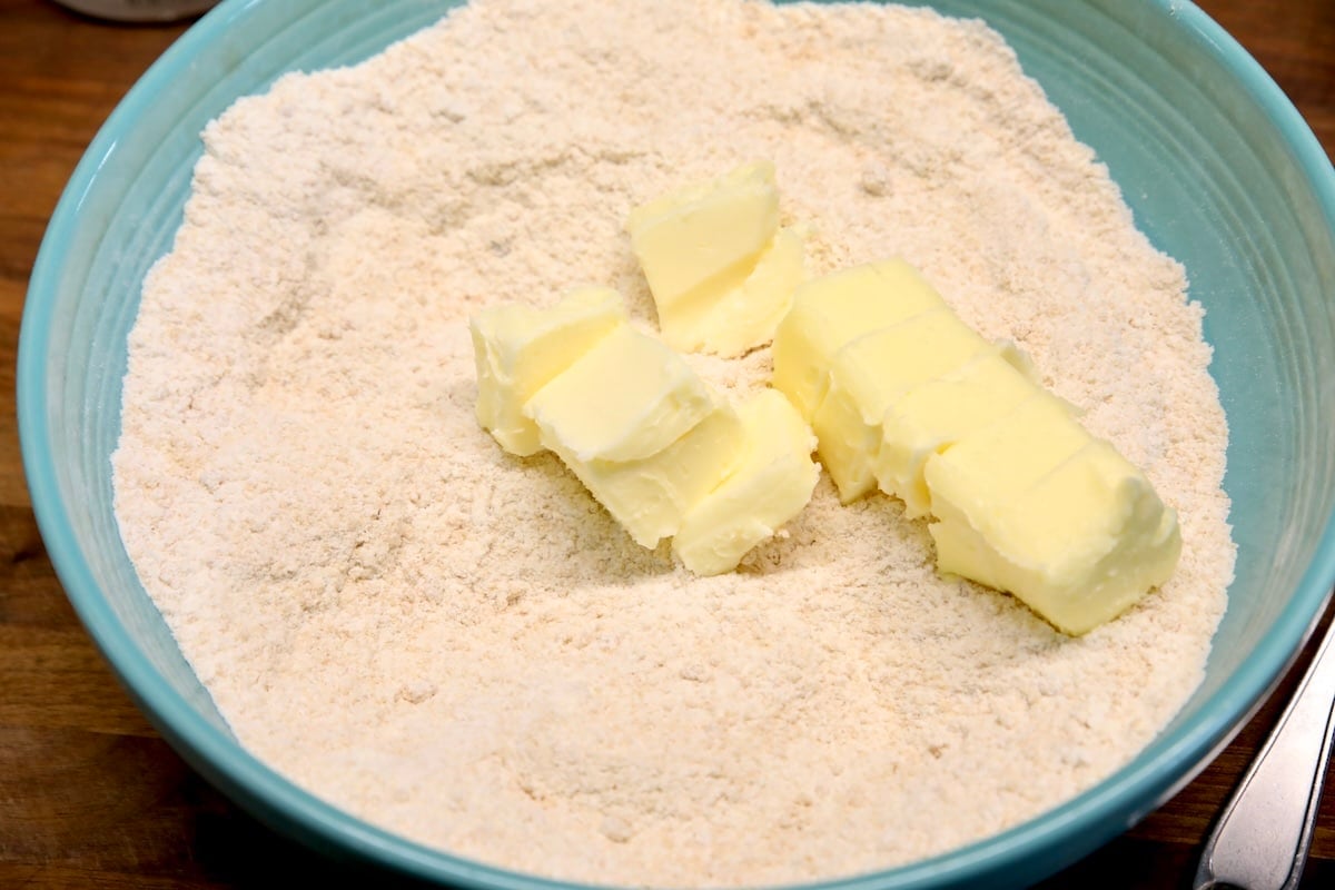 Making crumble topping with butter.