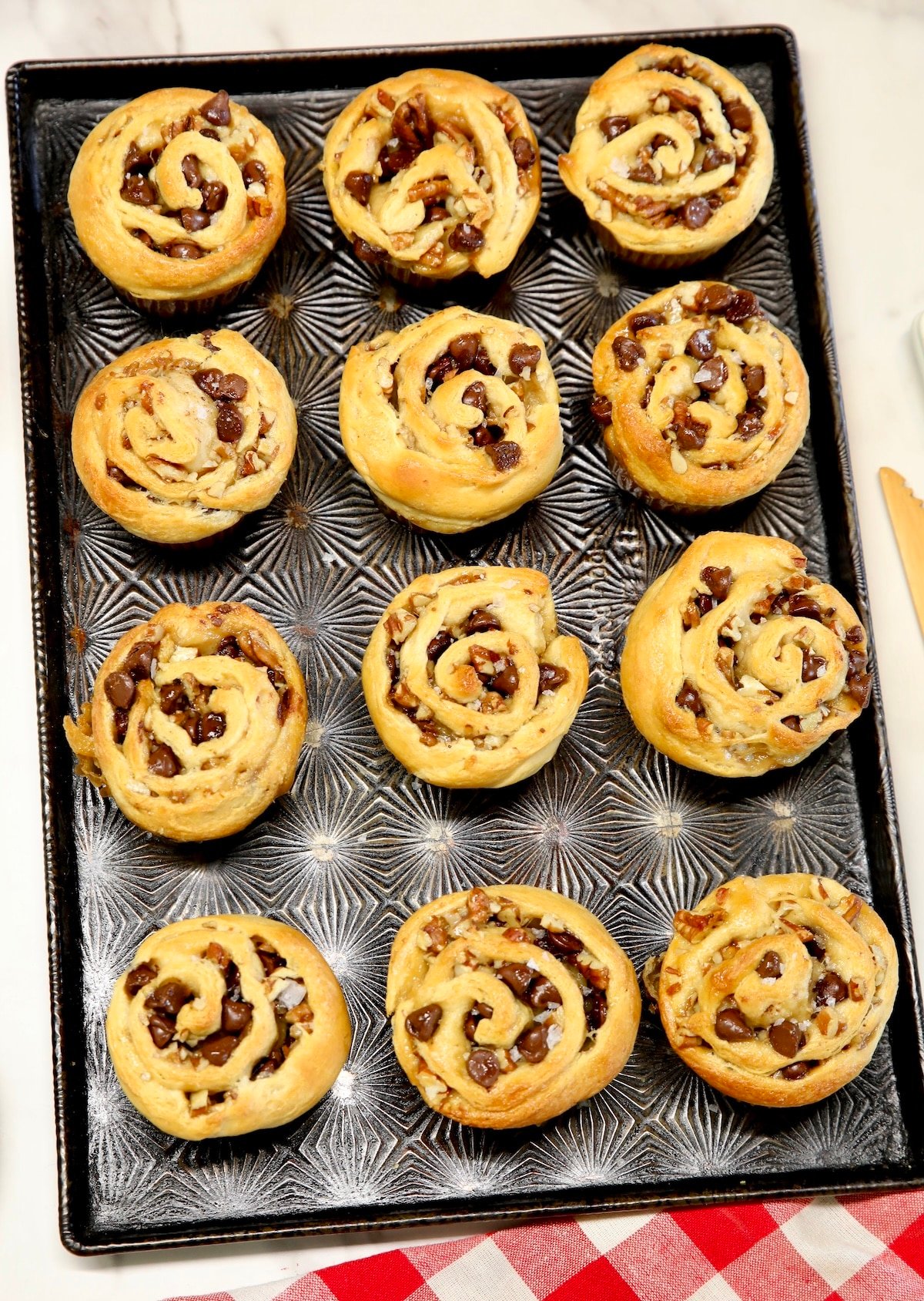Pan of chocolate, caramel pecan croissant muffins.