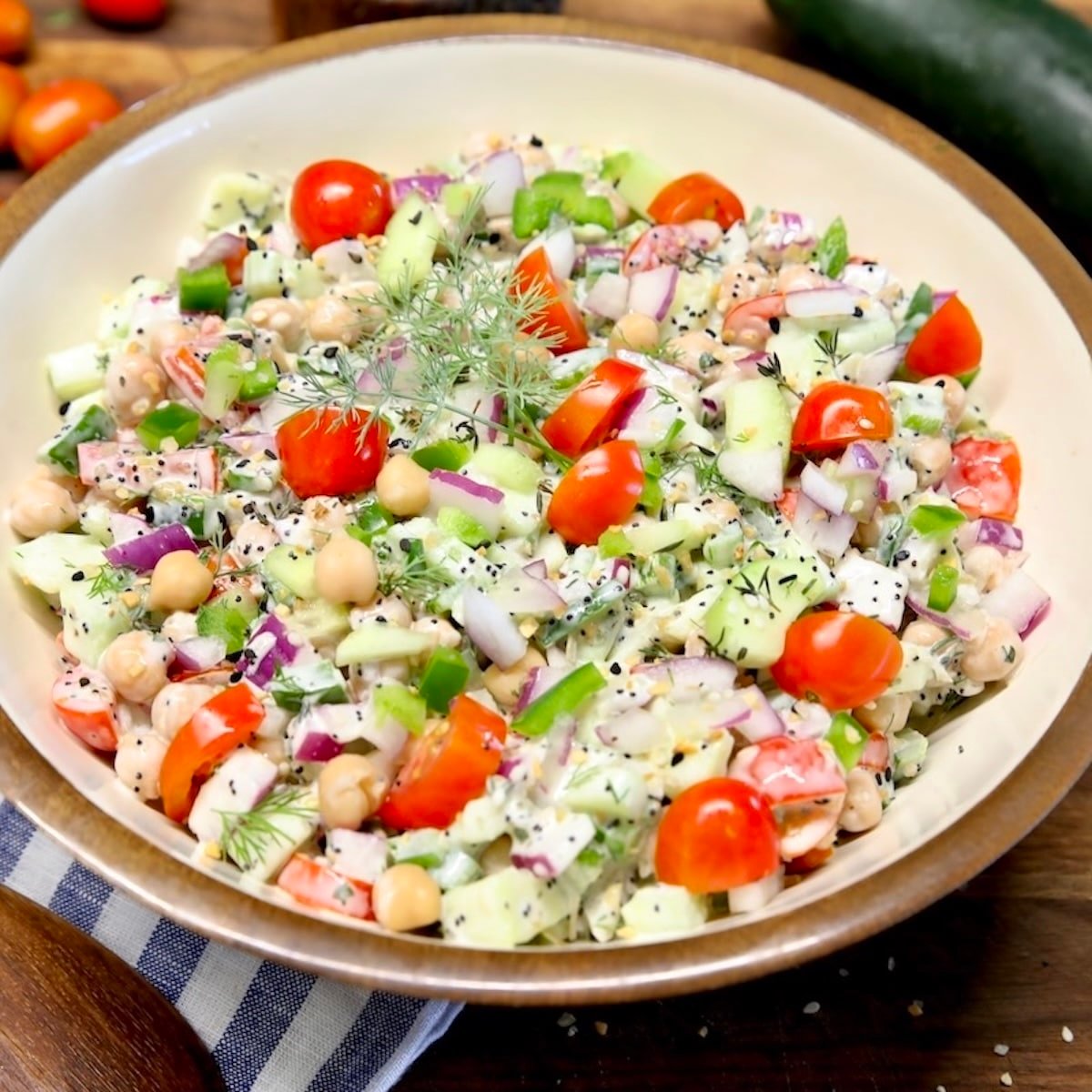 Chickpea salad with cucumbers, tomatoes, creamy dressing.