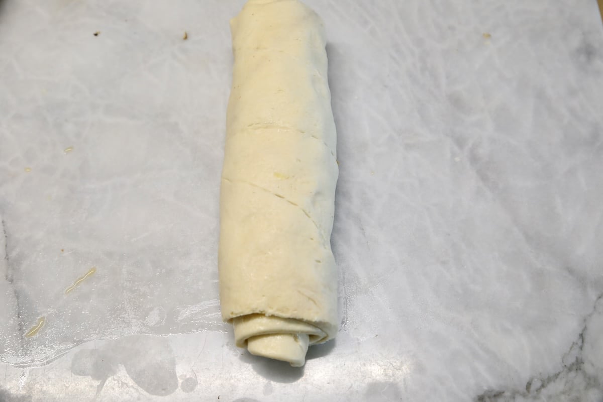 Filled crescent dough roll up into a log.