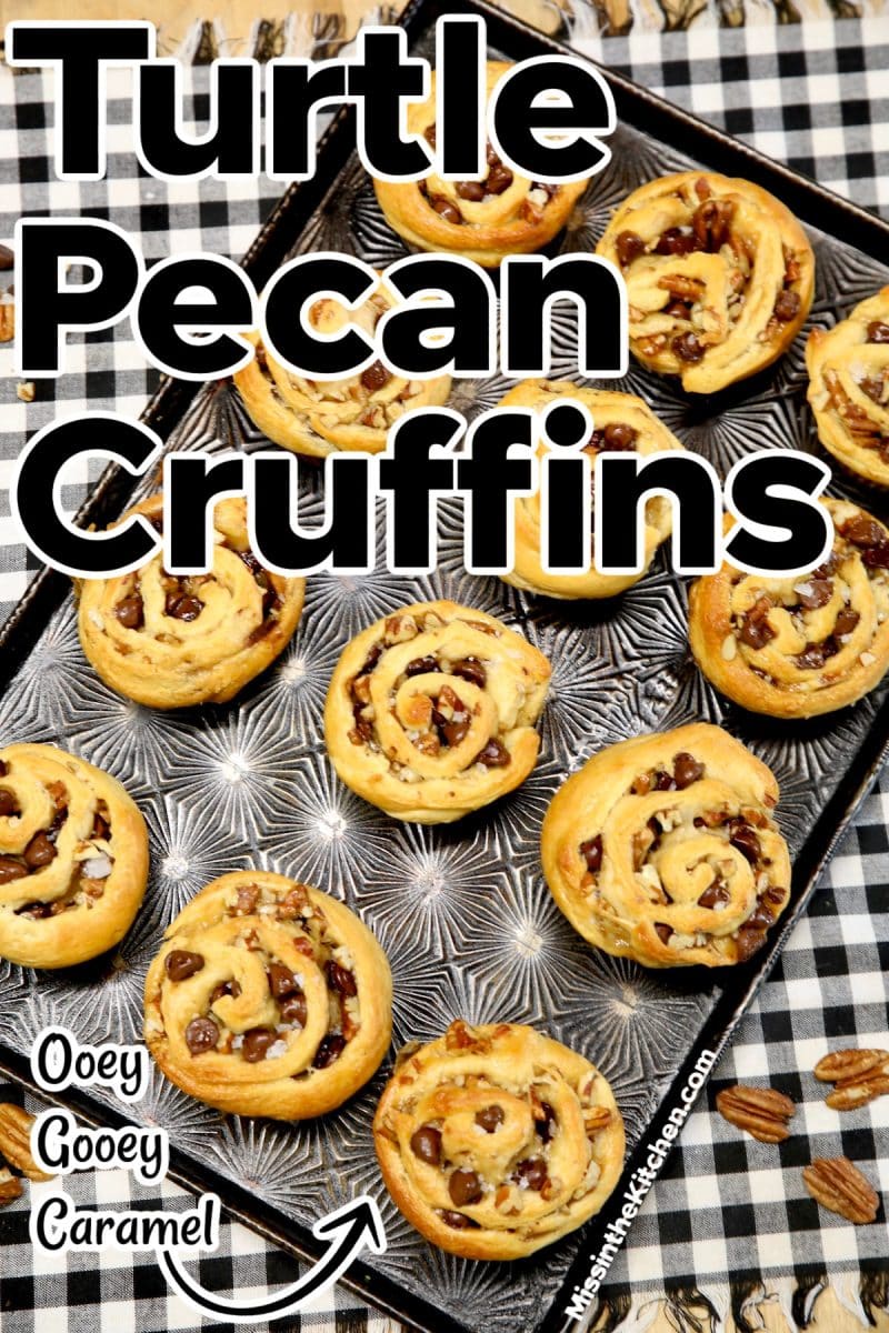 Turtle pecan cruffins on a black pan.
