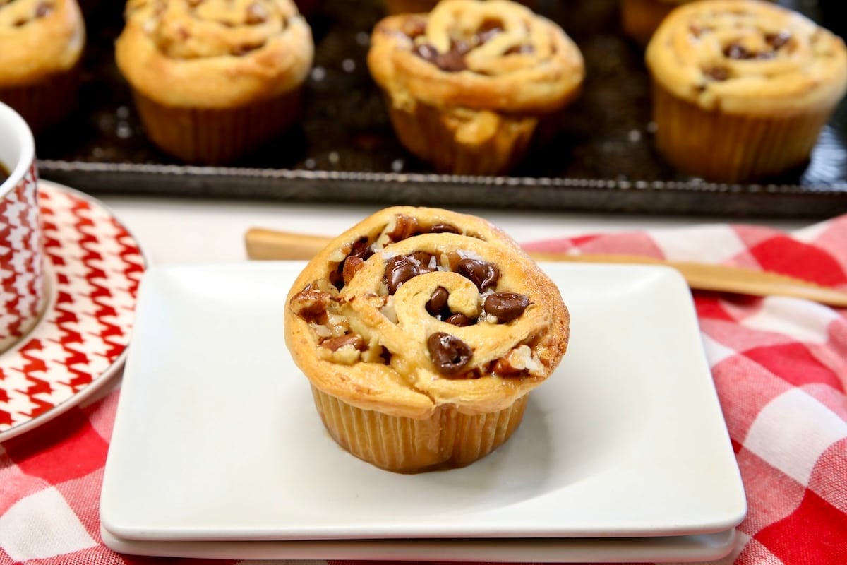Cruffin on a plate with caramel and chocolate chips.