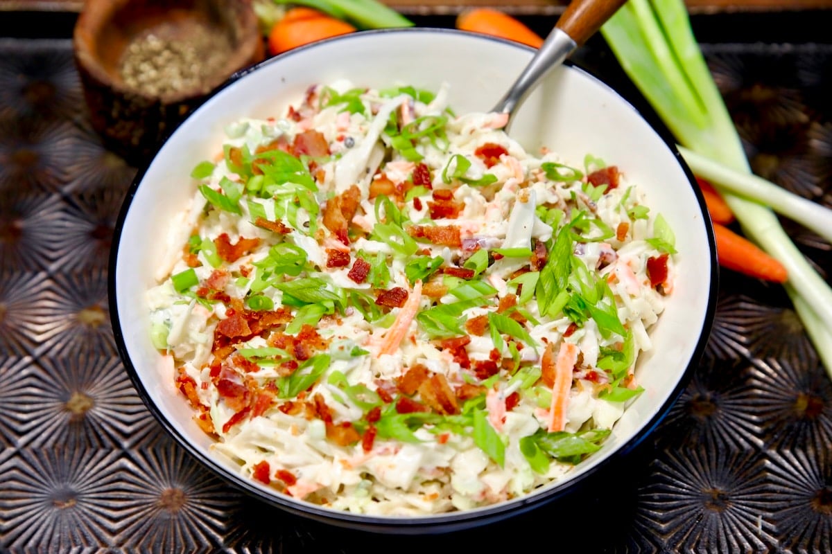 Cabbage and carrot slaw with bacon and green onions.