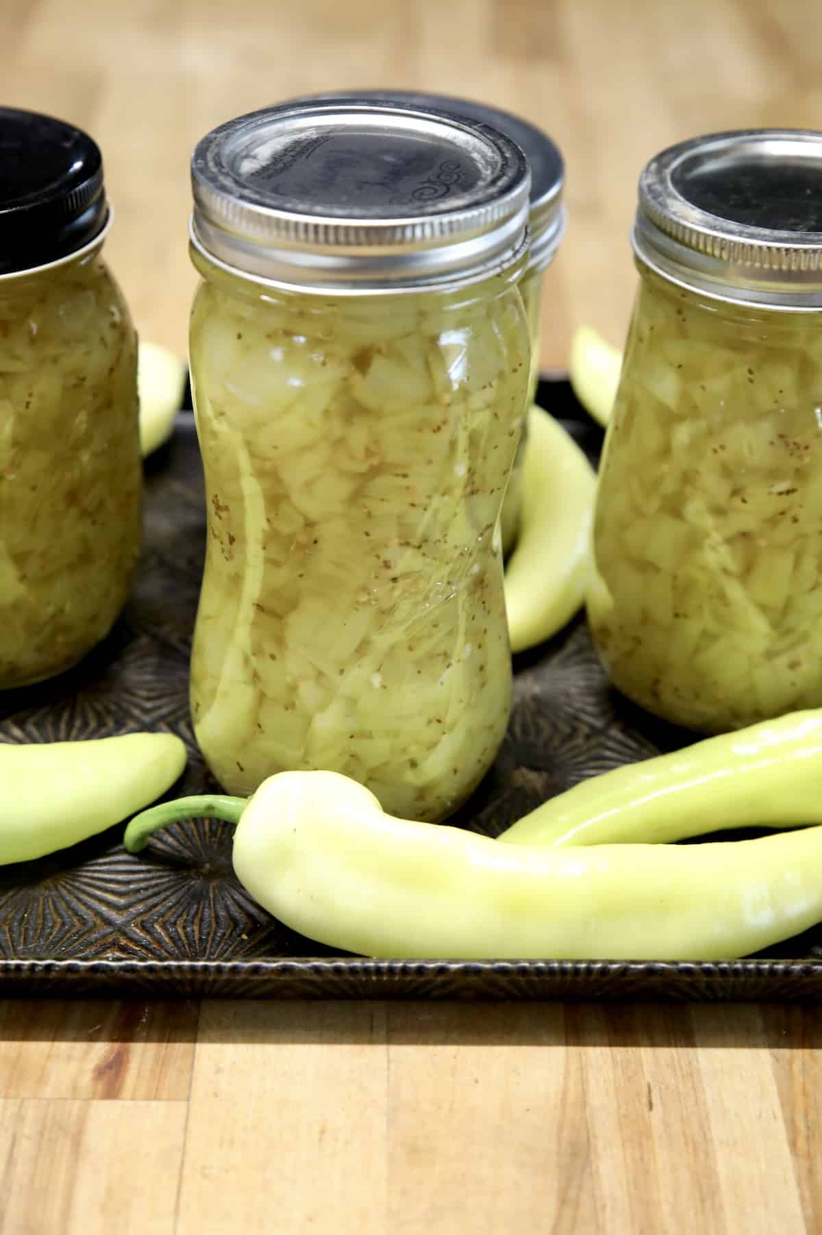 Banana Pepper Relish in canning jars with fresh banana peppers.