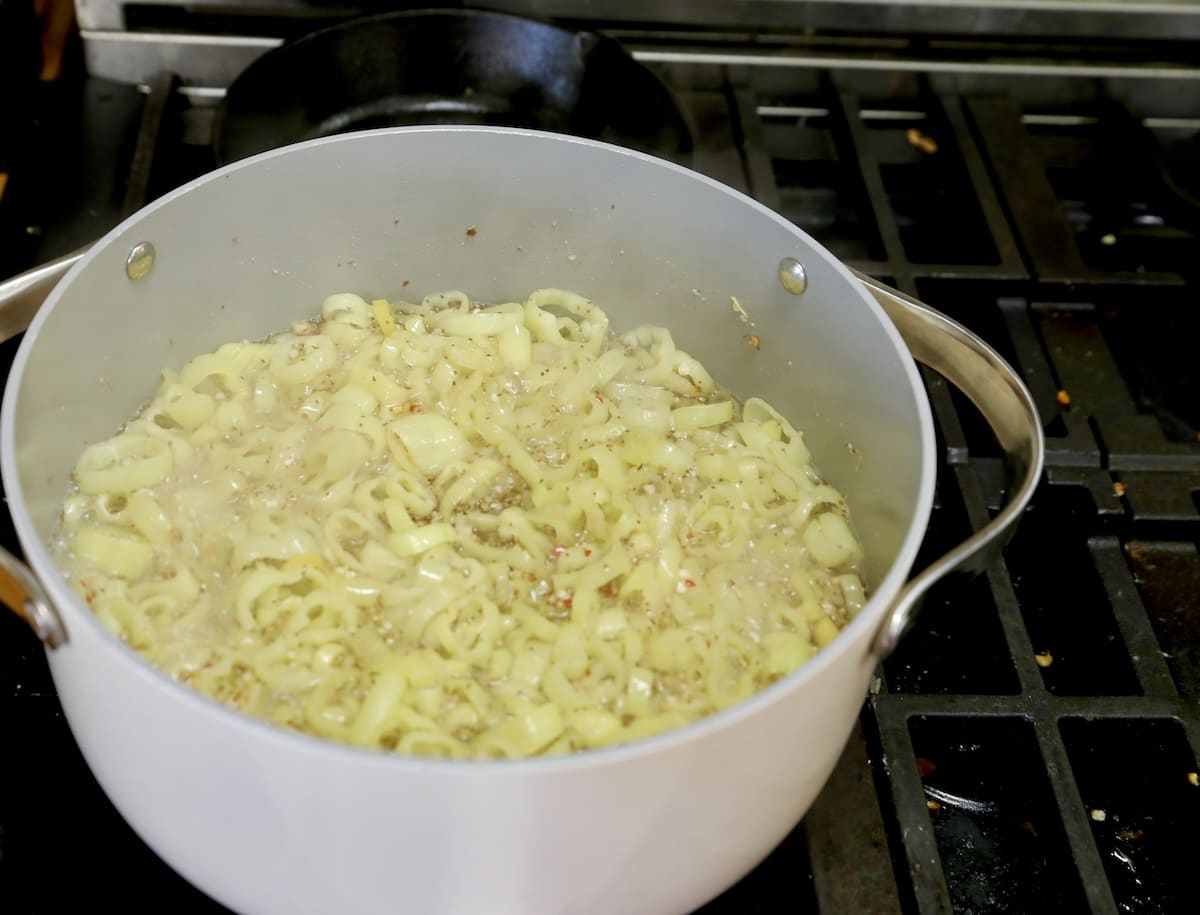 Cooking banana pepper relish in a pan.
