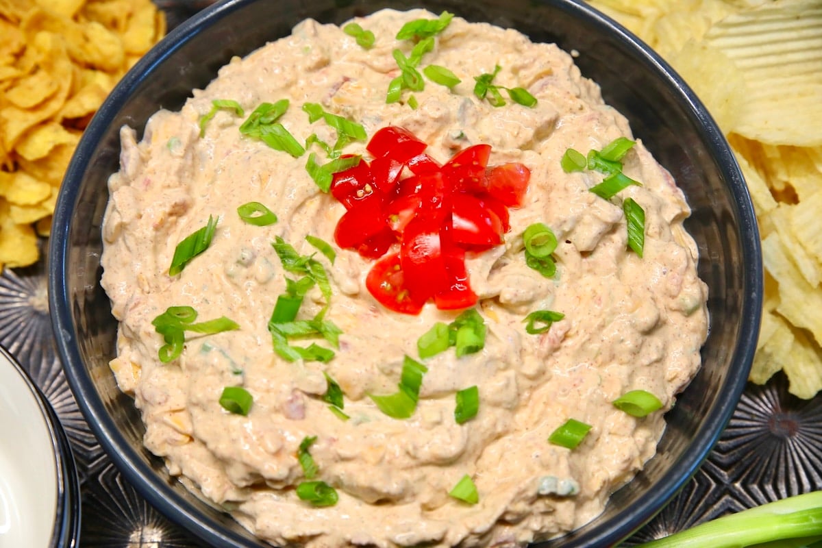 Boat dip with tomato garnish.