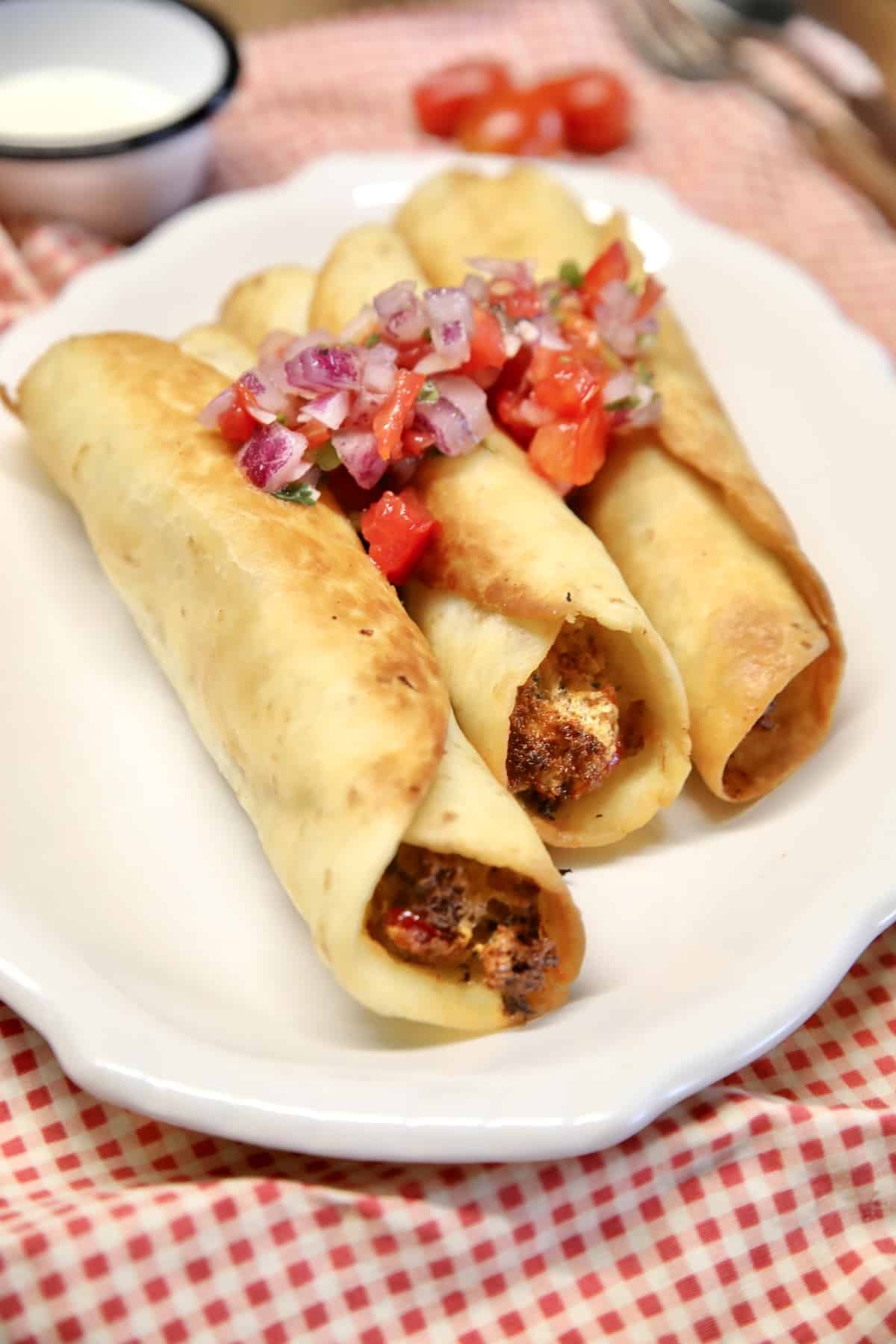 Platter of fried brisket jalapeno popper taquitos.