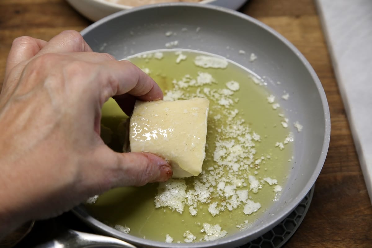 Dipping roll in melted butter.