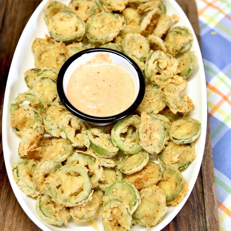 Platter of fried jalapenos with cup of sauce.