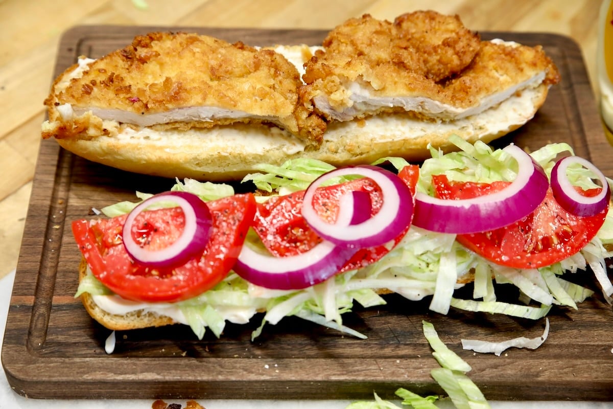 Pork chop hoagie with lettuce, tomato, red onion.