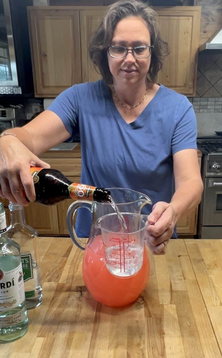 Pouring triple sec into pitcher.