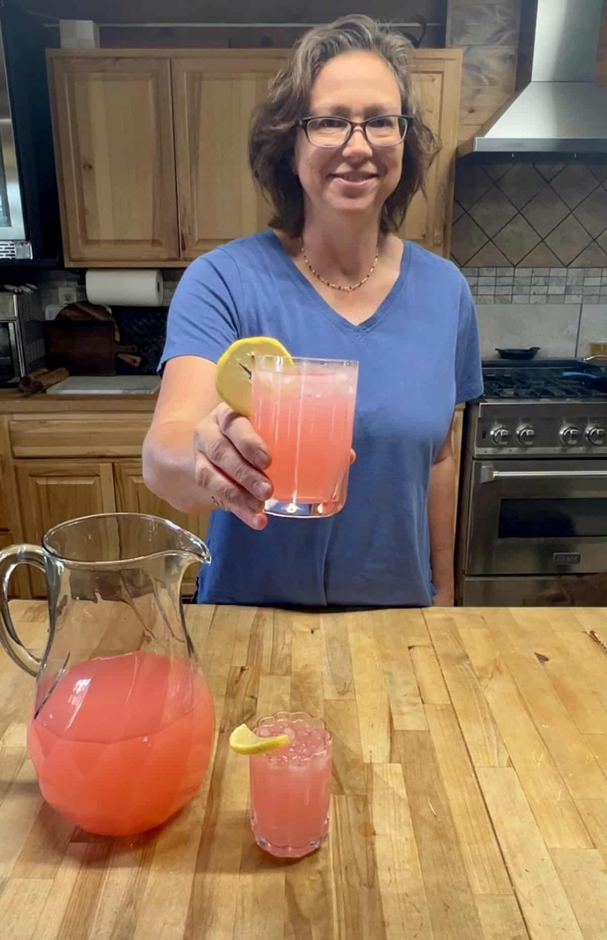 Miss holding Lemonade Hippie Juice punch in a glass. 