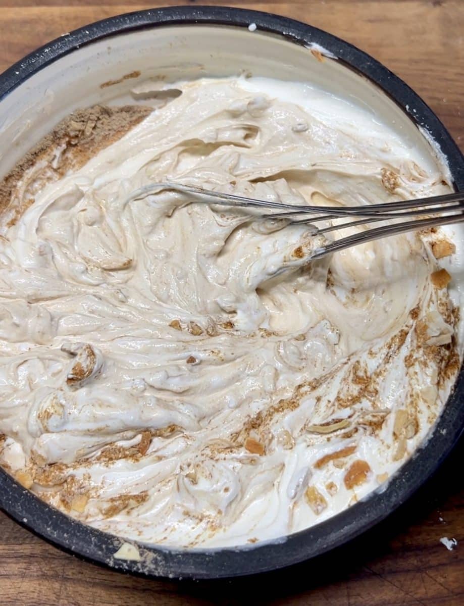 Mixing sour cream and onion soup mix in a bowl.