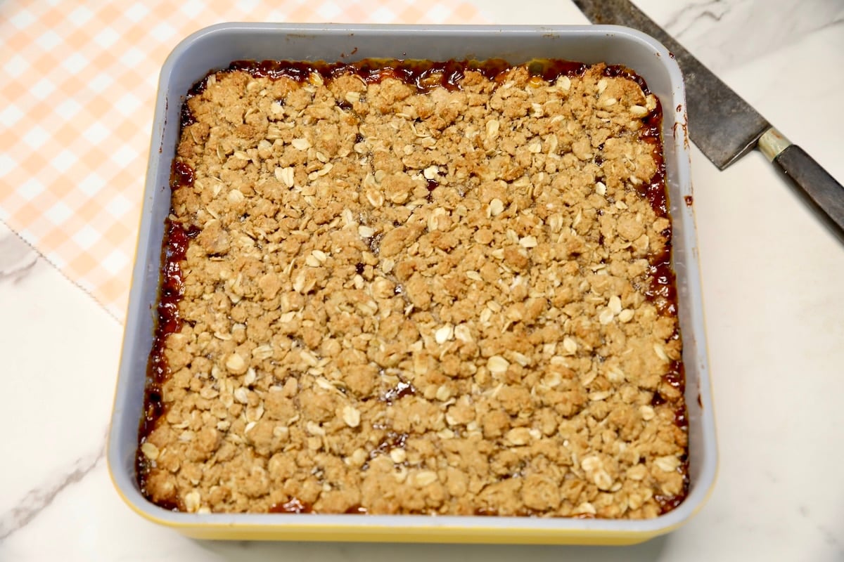 Baked peach oat bars in square pan.