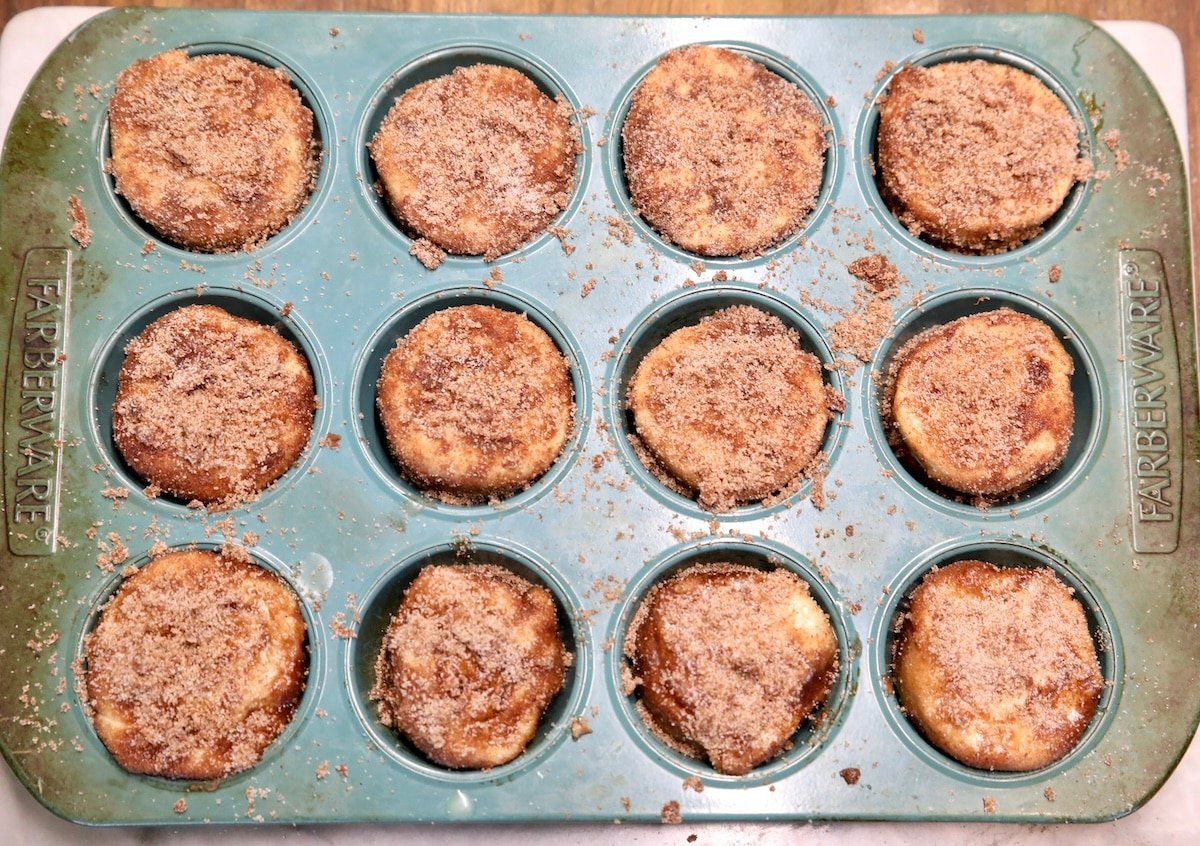 Muffin tin with cinnamon sugar coated cruffins.