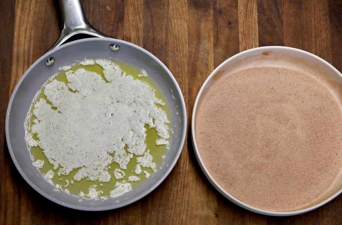 Pan with melted butter, bowl of cinnamon sugar.
