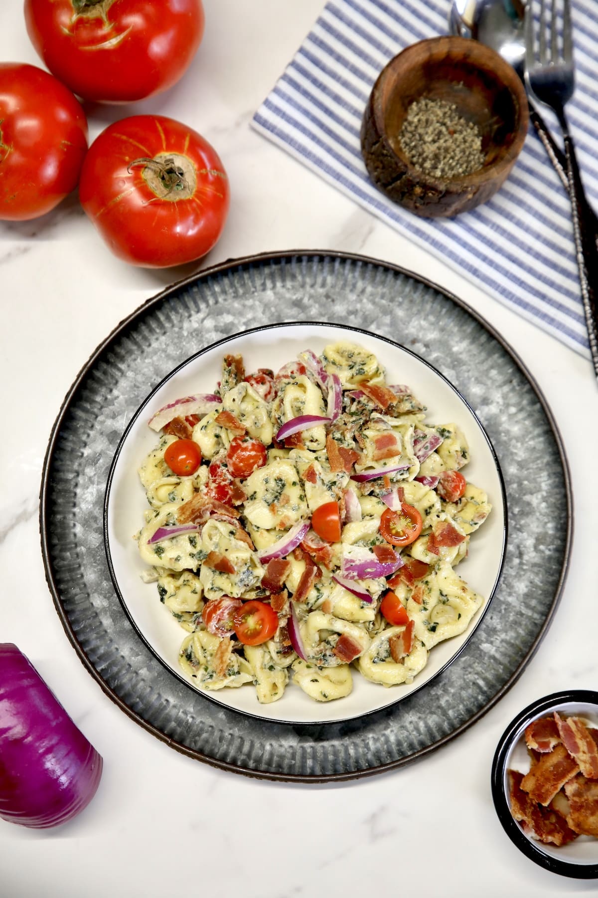 Bowl of tomato and bacon pasta salad.