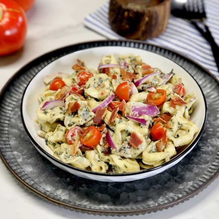 Tortellini Pasta salad in a bowl with bacon and tomatoes.
