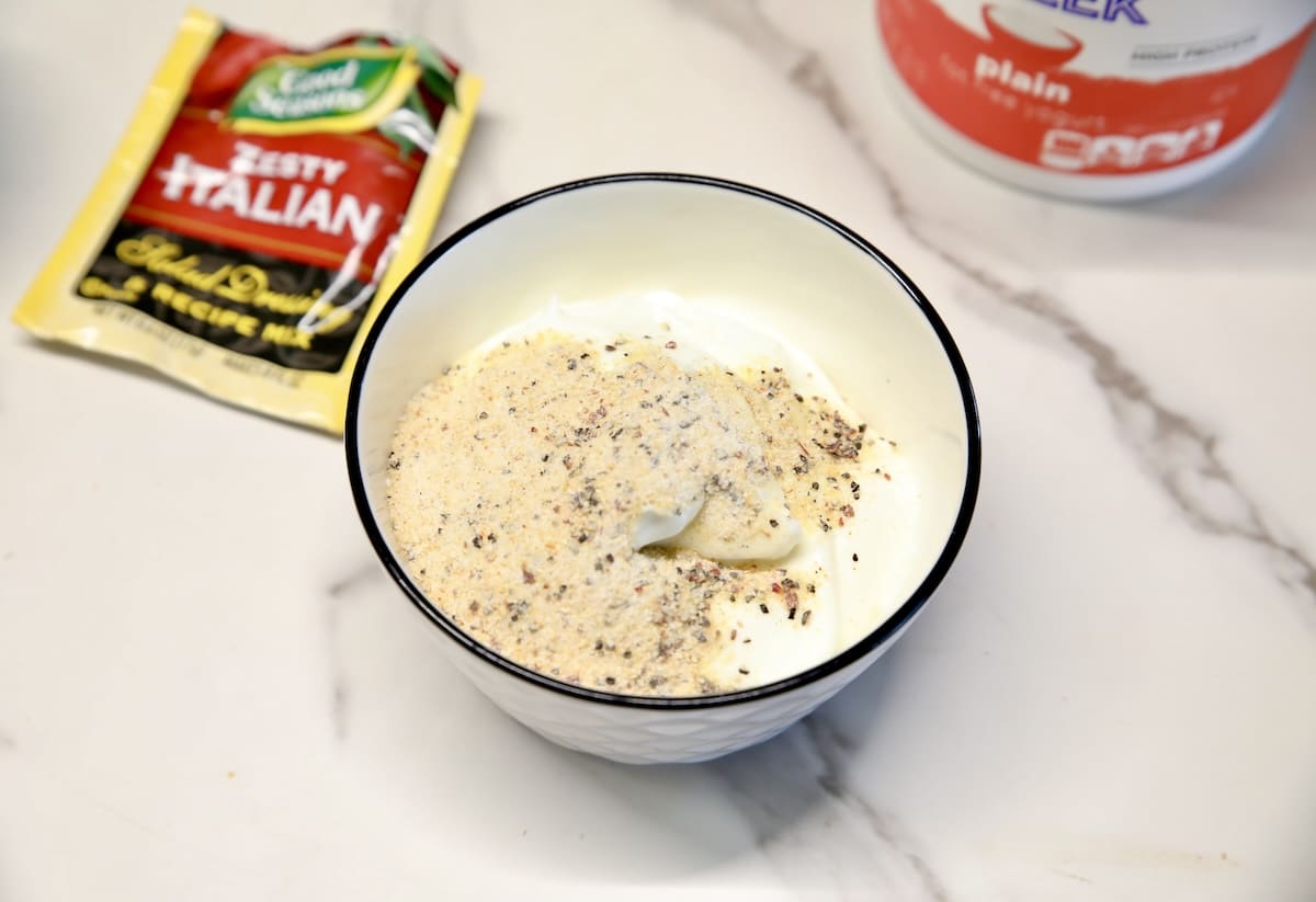 Greek yogurt in a bowl with Italian dressing mix.