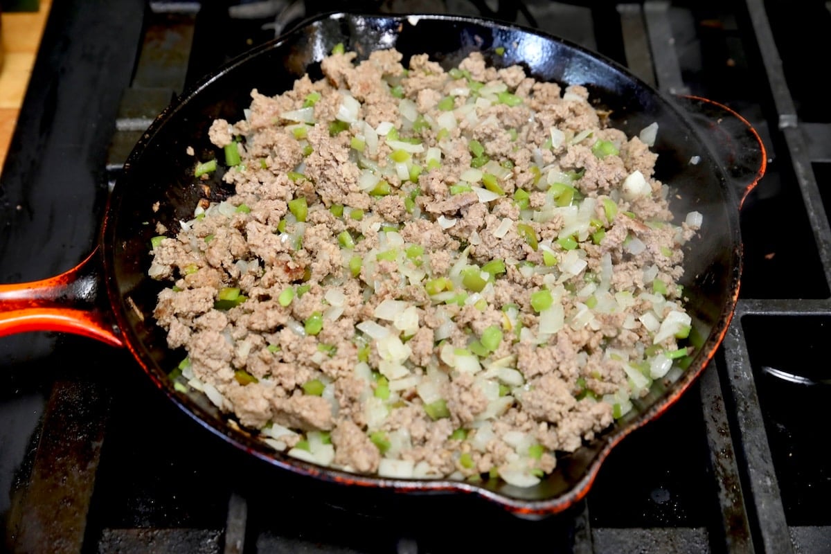 Skillet of cooked ground beef, onions, bell peppers. 
