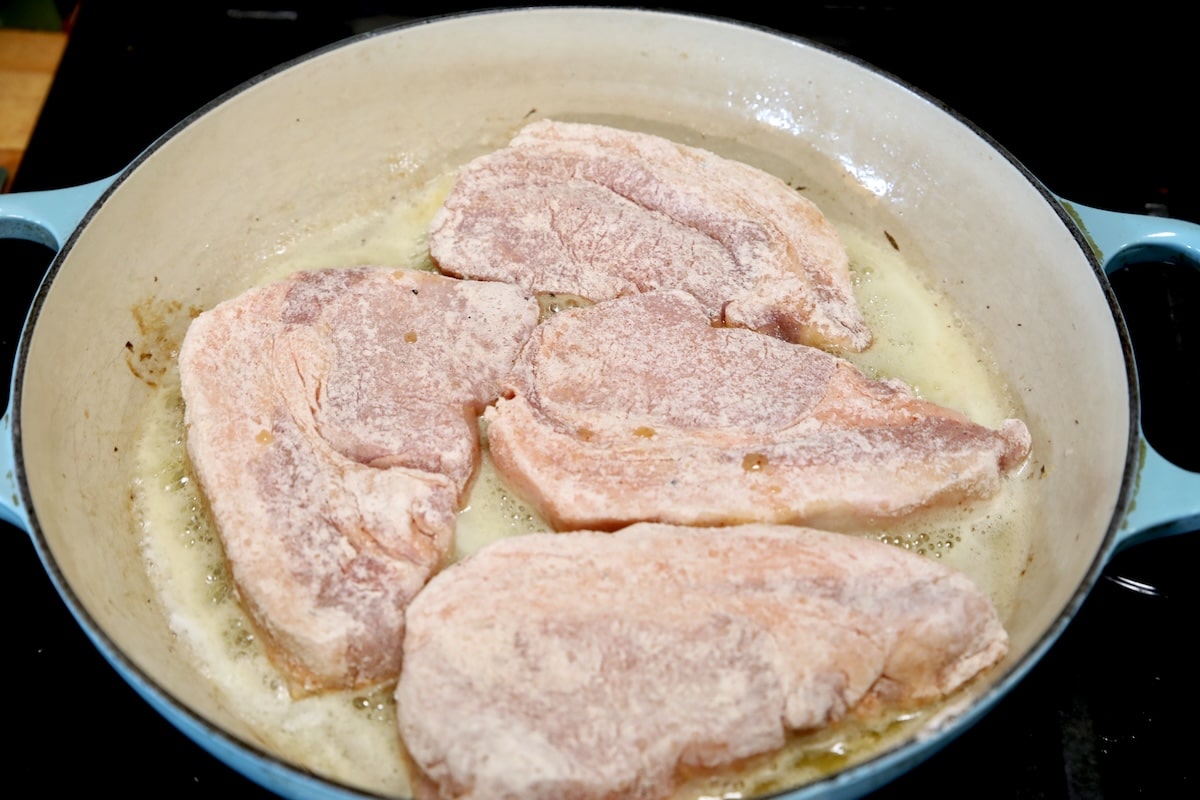 4 pork chops in a skillet.