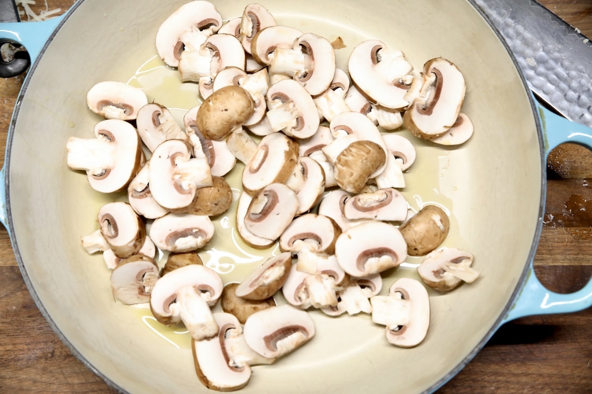 Sliced mushrooms in a skillet.